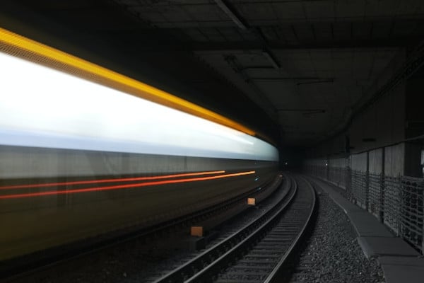 a-blurry-photo-of-a-train-going-through-a-tunnel-600