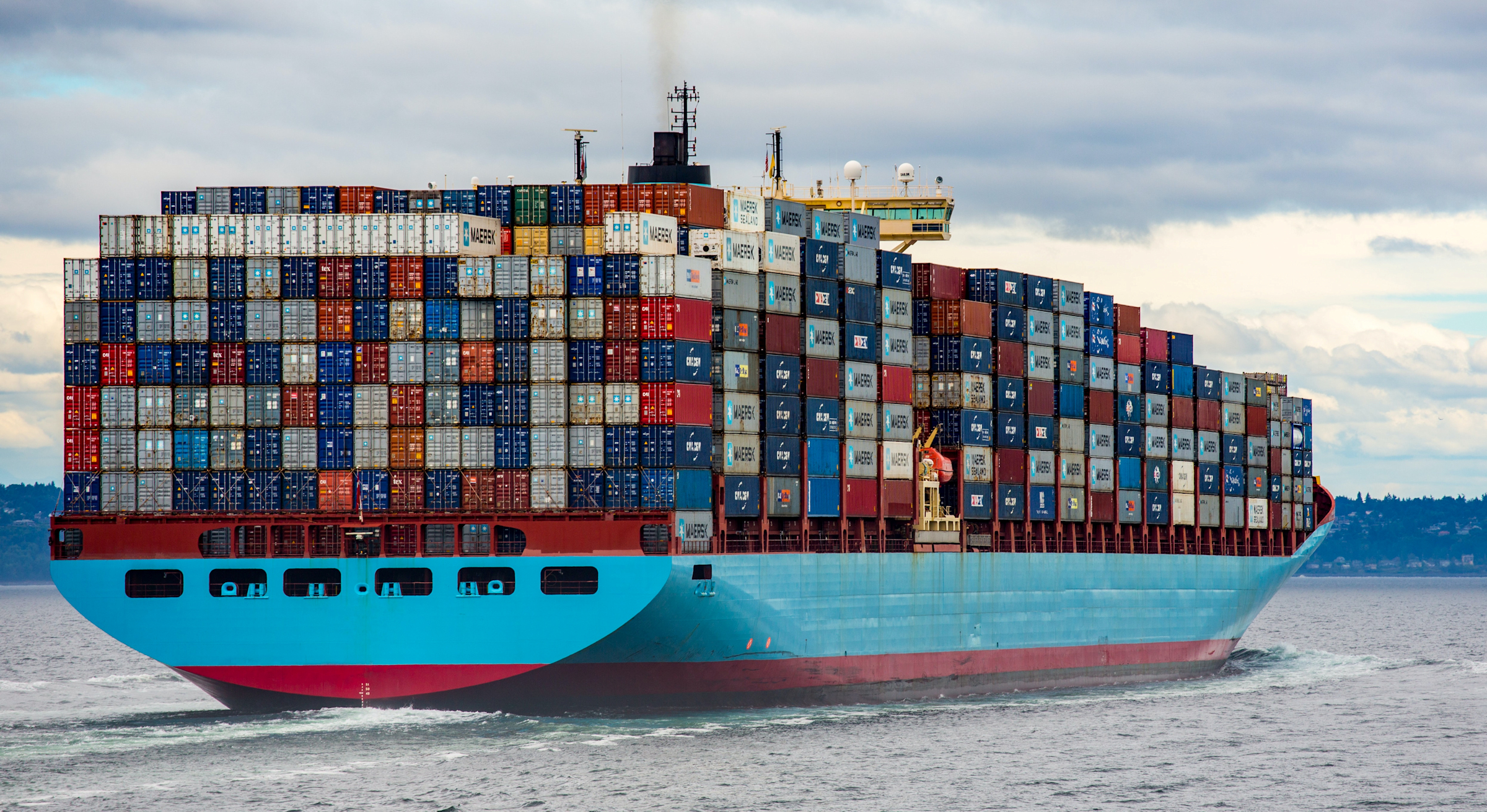 A container ship loaded high with containers.